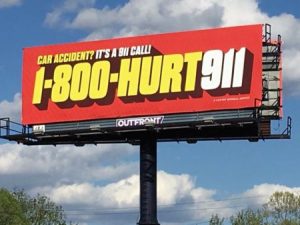 A lawyer vanity phone number advertised on a billboard